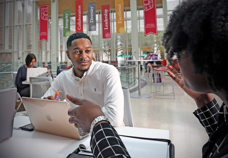 Students conversing at a table.