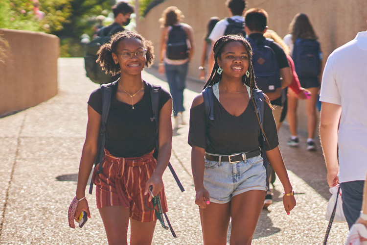 Two students walking on campus.